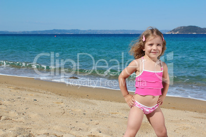 beauty little girl posing on the beach