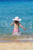 little girl running in sea