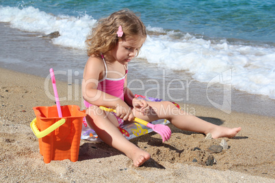 little girl playing on the beach