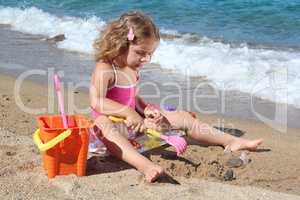 little girl playing on the beach