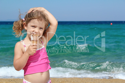 young girl with ice cream on the beach