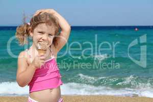young girl with ice cream on the beach