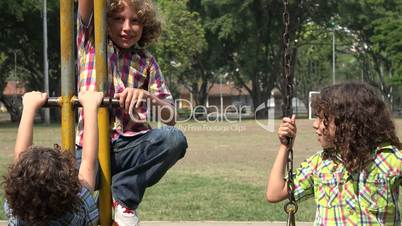 Brothers Playing on Swing Set