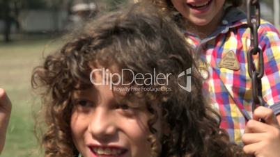 Mentally Disabled Boy and Brothers on Swing