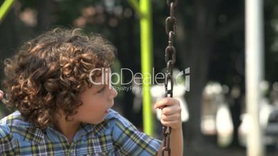 Boy Swinging on Swing Set