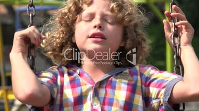 Boy Swinging on Swing Set