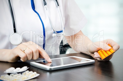 Doctor working on a digital tablet