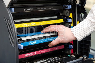 Man puts toner in the printer