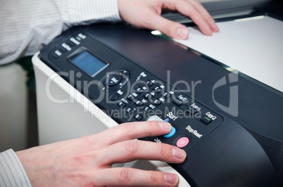 Man using scanner multifunction device in office