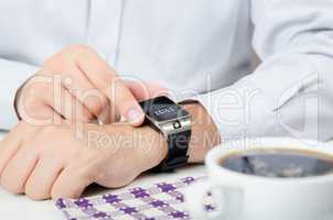 Businessman working with smart watch in restaurant