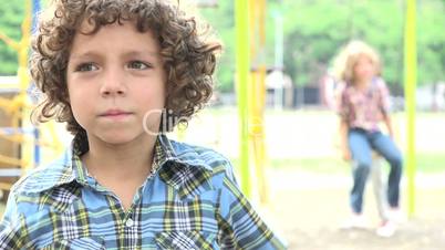 Sad Young Boy at Playground