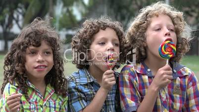 Brothers Eating Lollipop Candy