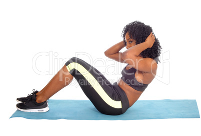 African American woman doing sit-up's.