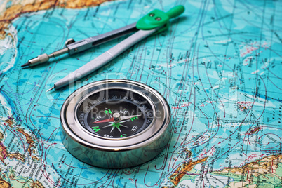 outdated compass sailor on topographic map