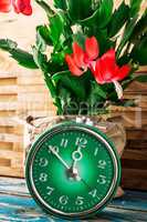 symbol of spring green clock and blossoming flower