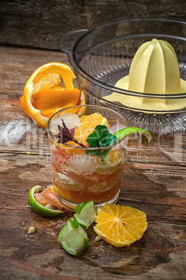 fresh juice of tropical citrus fruits on wooden background