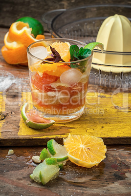fresh juice of tropical citrus fruits on wooden background