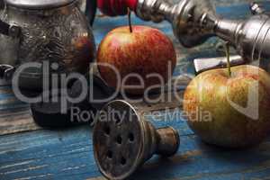 details smoking hookah on background of apples