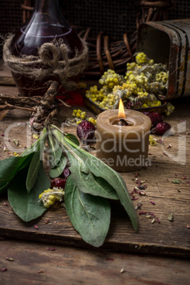 medicinal herb and burning candle