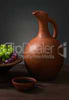 red wine with grapes and a pitcher
