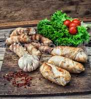 set fried meat sausages on wooden background