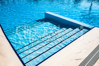 Stairs clear blue swimming pool