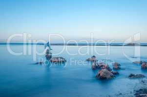 long exposure of statue of dolphin in the water in sardinia - it