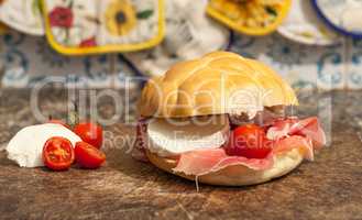 sanwich with ham, little tomatoes and mozzarella
