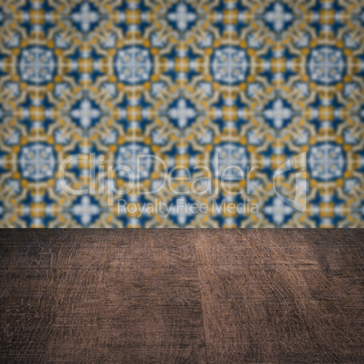 Wood table top and blur vintage ceramic tile pattern wall