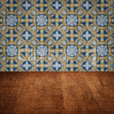 Wood table top and blur vintage ceramic tile pattern wall