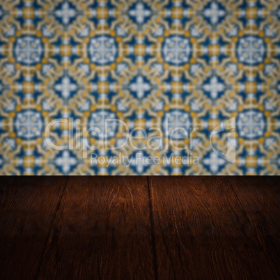 Wood table top and blur vintage ceramic tile pattern wall