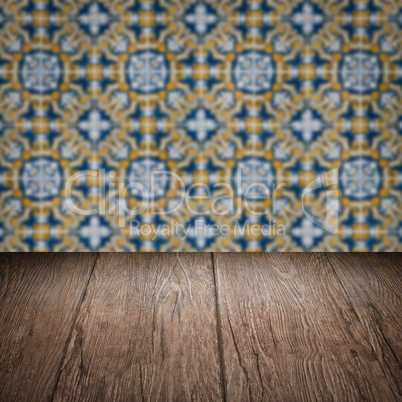 Wood table top and blur vintage ceramic tile pattern wall