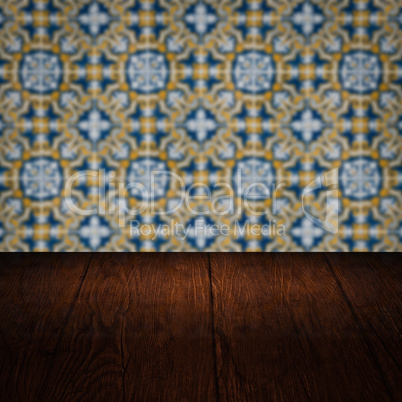 Wood table top and blur vintage ceramic tile pattern wall Wood table top and blur vintage ceramic tile pattern wall