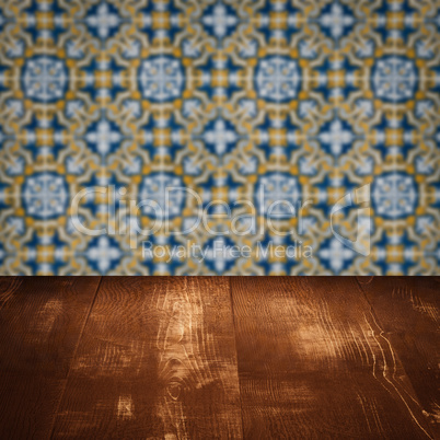 Wood table top and blur vintage ceramic tile pattern wall