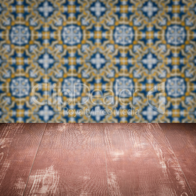 Wood table top and blur vintage ceramic tile pattern wall