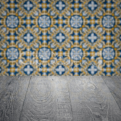 Wood table top and blur vintage ceramic tile pattern wall