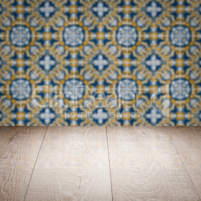 Wood table top and blur vintage ceramic tile pattern wall