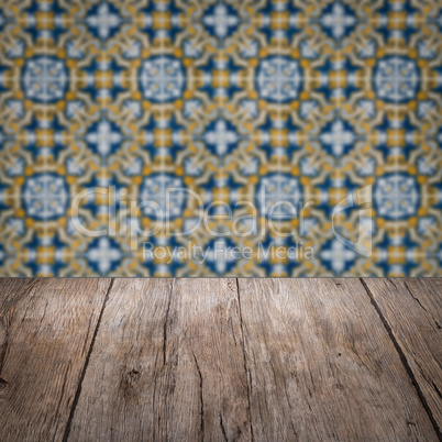 Wood table top and blur vintage ceramic tile pattern wall