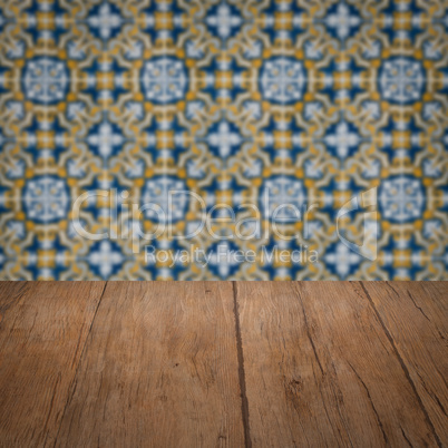 Wood table top and blur vintage ceramic tile pattern wall