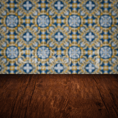 Wood table top and blur vintage ceramic tile pattern wall