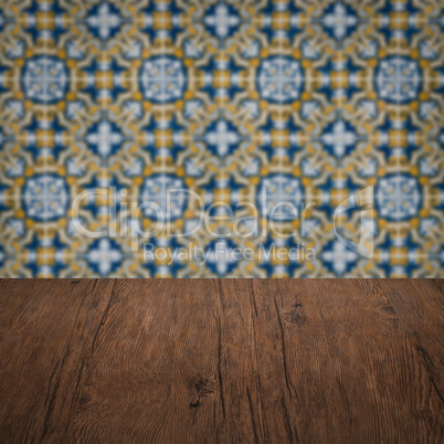 Wood table top and blur vintage ceramic tile pattern wall