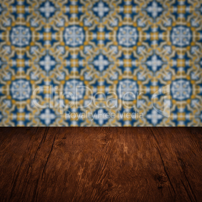 Wood table top and blur vintage ceramic tile pattern wall