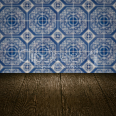 Wood table top and blur vintage ceramic tile pattern wall