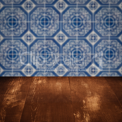 Wood table top and blur vintage ceramic tile pattern wall