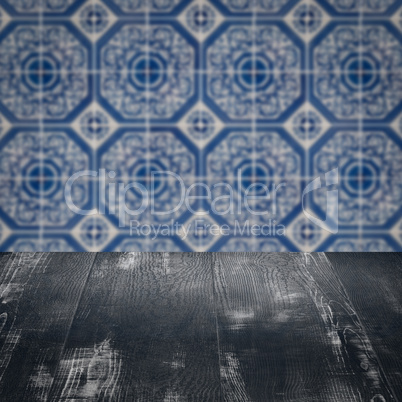 Wood table top and blur vintage ceramic tile pattern wall