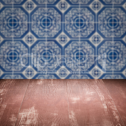 Wood table top and blur vintage ceramic tile pattern wall