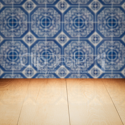 Wood table top and blur vintage ceramic tile pattern wall