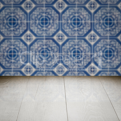 Wood table top and blur vintage ceramic tile pattern wall