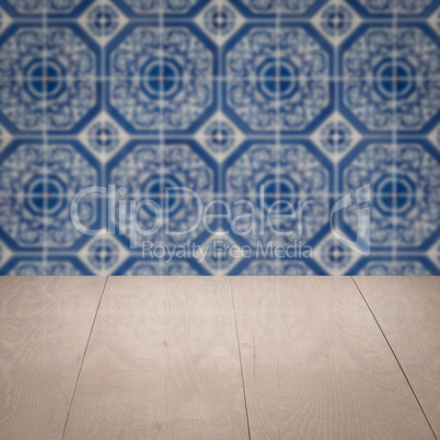 Wood table top and blur vintage ceramic tile pattern wall