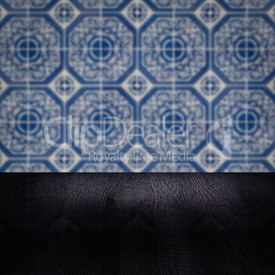Wood table top and blur vintage ceramic tile pattern wall